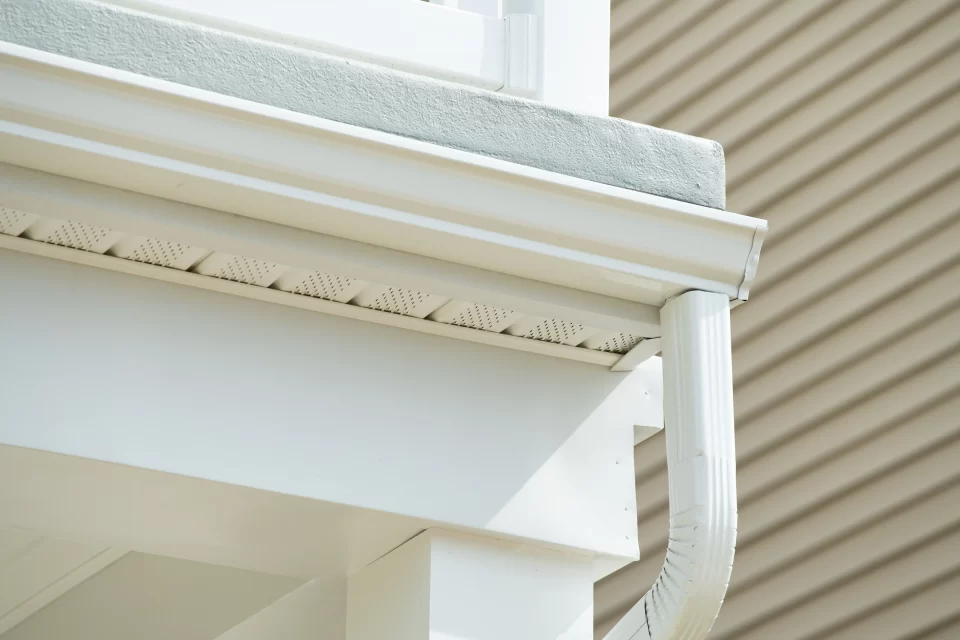 Image of a white home with new gutters installed.
